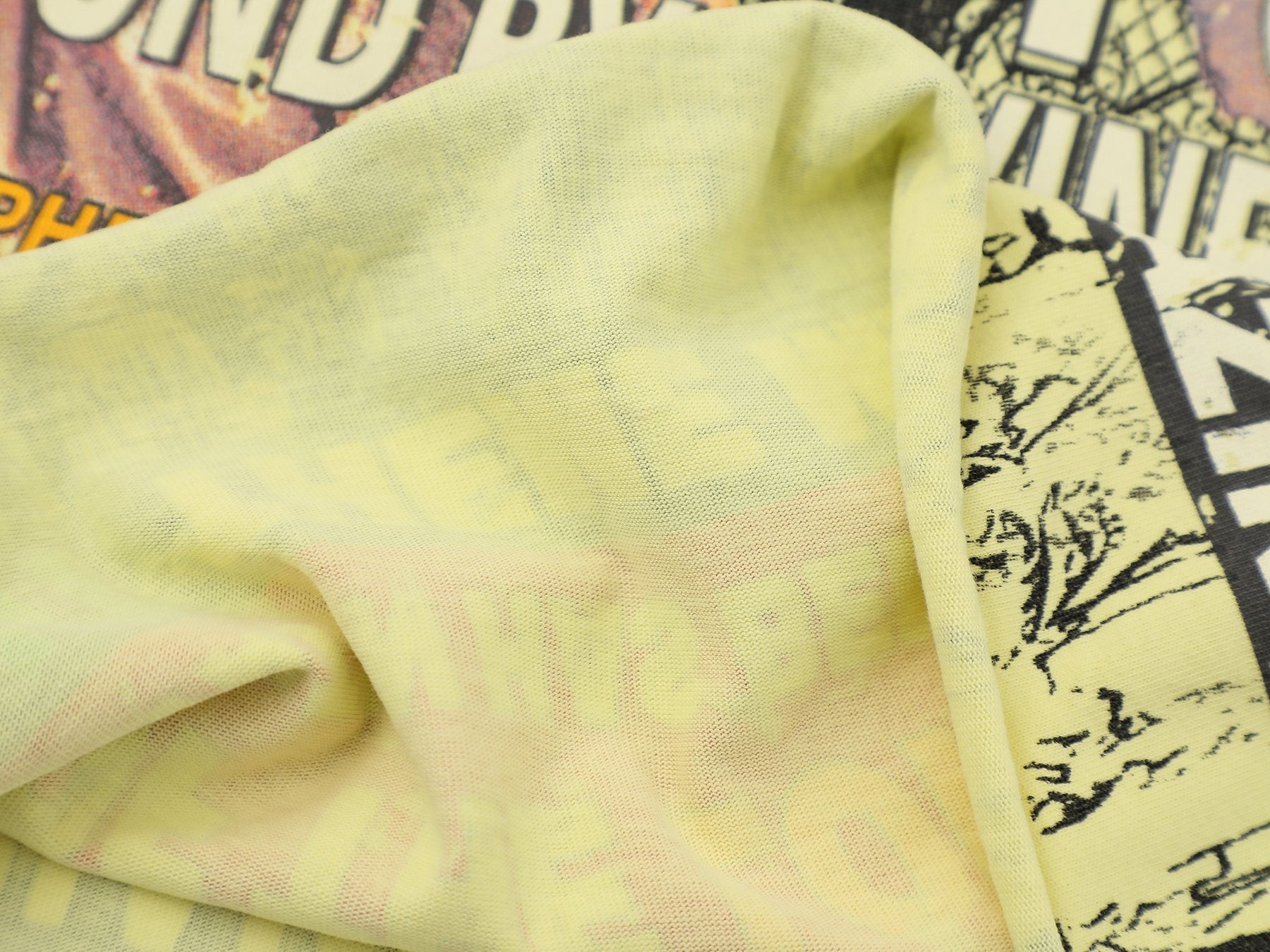 FIRST ROW Wings of Purity Yellow Graphic T-Shirt — fabric_closeup