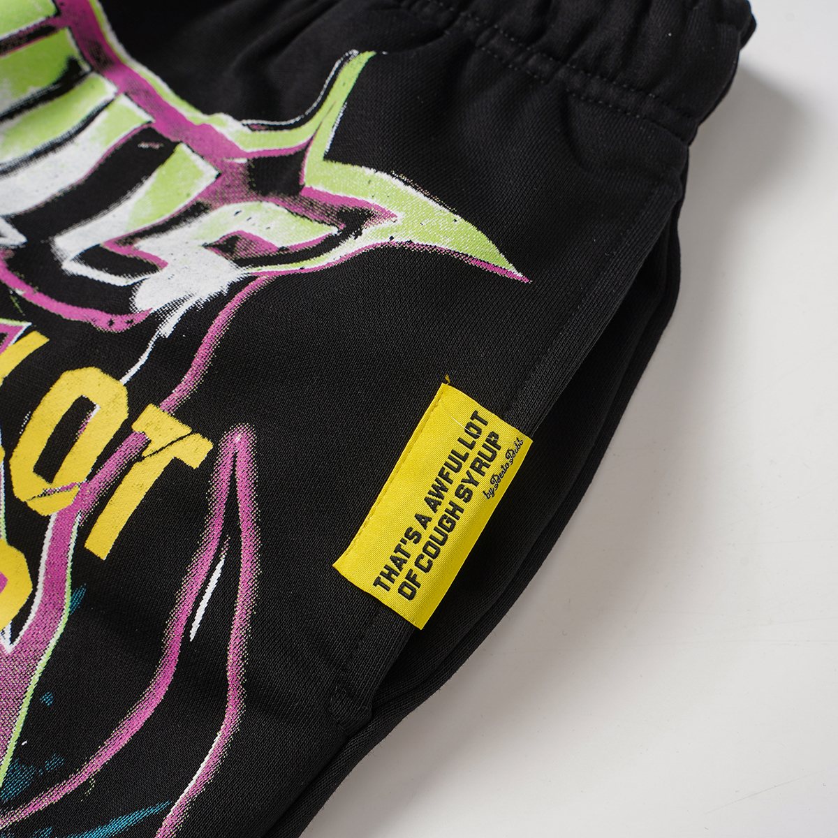 THAT'S A AWFUL LOT OF COUGH SYRUP Black Graphic Drawstring Shorts — detail