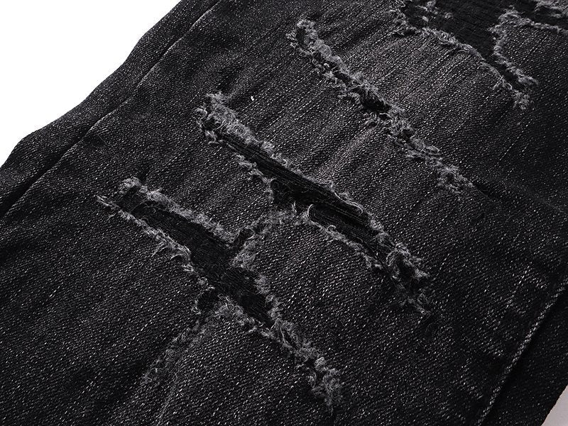 AMIRI Varsity Letter Appliqué Distressed Jeans — detail