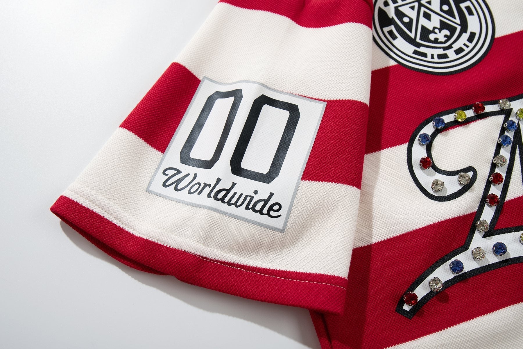 MAJESTIK Striped Crest Graphic Polo Shirt — detail